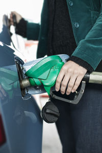 Woman filling car with gas