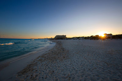 Scenic view of sea against clear sky during sunset