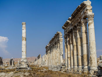 Roman column street against clear blue sky