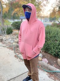 Rear view of man standing on footpath