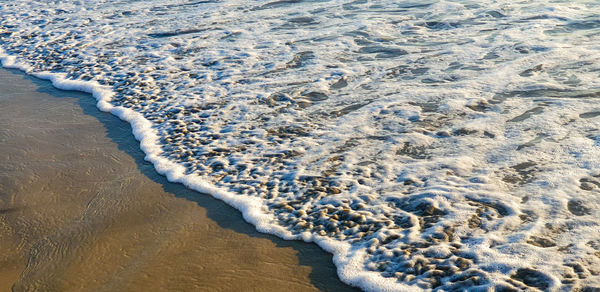 High angle view of surf on beach