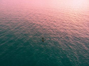 Aerial view of boat in sea during sunset