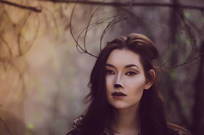 Portrait of young woman at forest