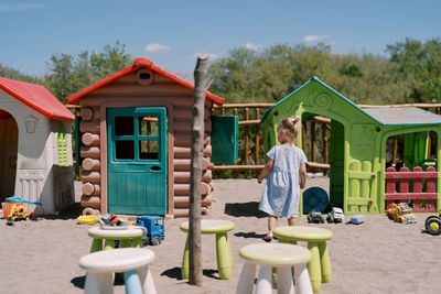 Rear view of woman sitting on beach
