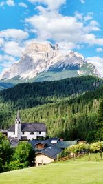 Houses on mountain against sky