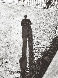 High angle view of man shadow on street