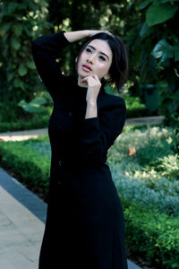 Portrait of young woman standing outdoors