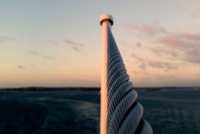 Close-up of sea against sky at sunset