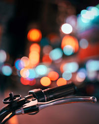 Close-up of cycle handbrake with city night bokeh