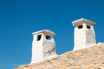 Low angle view of historical building against clear blue sky