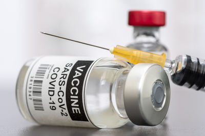 Close-up of vial and syringes on table