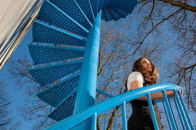 Low angle view of woman on staircase