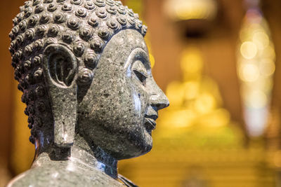 Close-up of buddha statue at temple