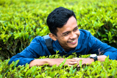 Portrait of smiling young man eating food