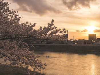 Scenic view of river against sky at sunset