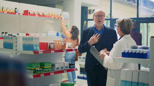 Portrait of female doctor examining chemical in laboratory