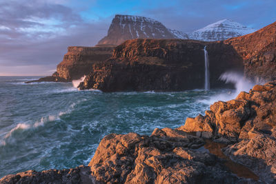Scenic view of sea and rocks against sky
