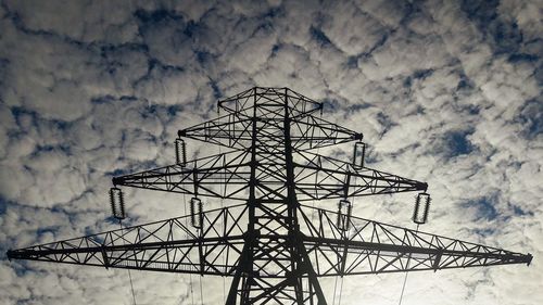 Low angle view of electricity pylon against sky