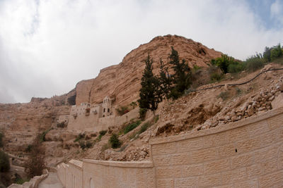 Low angle view of rock formations against sky