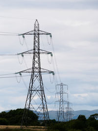 Low angle view of electricity pylon against sky