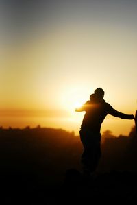 Silhouette of people at sunset