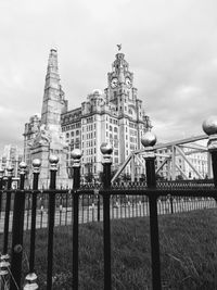 Buildings against cloudy sky