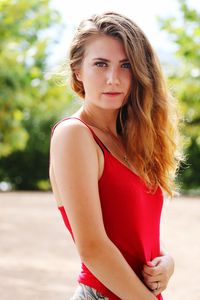 Portrait of beautiful young woman standing outdoors