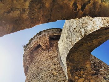 Low angle view of stone wall against sky