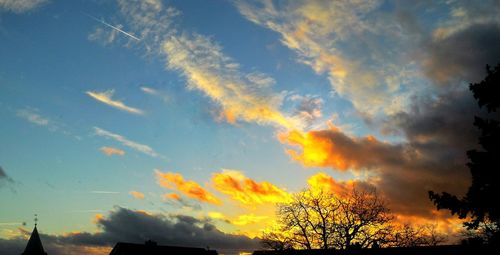 Low angle view of silhouette trees against sky at sunset