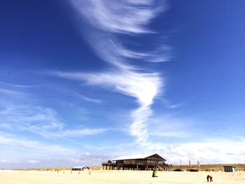 Scenic view of beach against cloudy sky