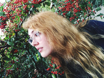 Portrait of young woman against plants