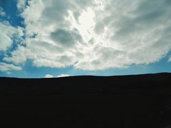 Silhouette landscape against sky