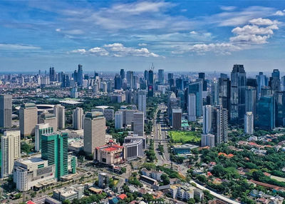 High angle view of modern buildings in city against sky