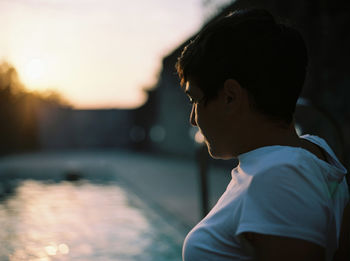 Side view of young man looking away at home