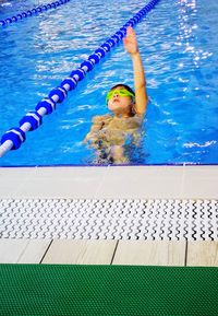 Boy swimming in pool