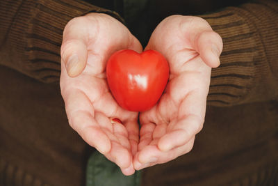 Close-up of hand holding heart shape