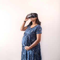 Full length of woman standing against white background