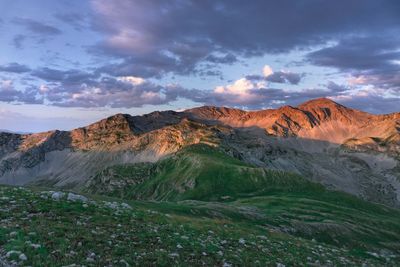 Scenic view of mountains against cloudy sky