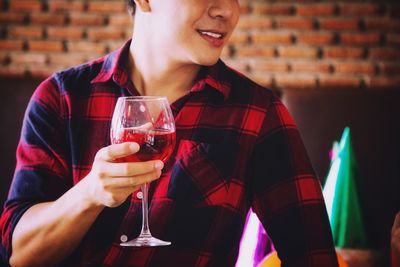 Midsection of man holding drink at party