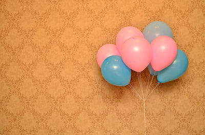 Close-up of balloons against wall