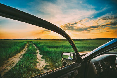 Scenic view of field against sky during sunset