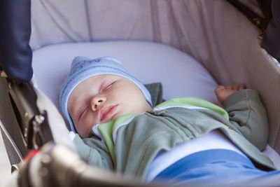 Low angle view of baby sleeping in bed