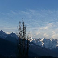 Scenic view of snow covered mountains against sky