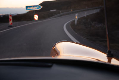 Close-up of car on road