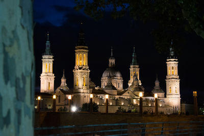 Illuminated building against sky at night