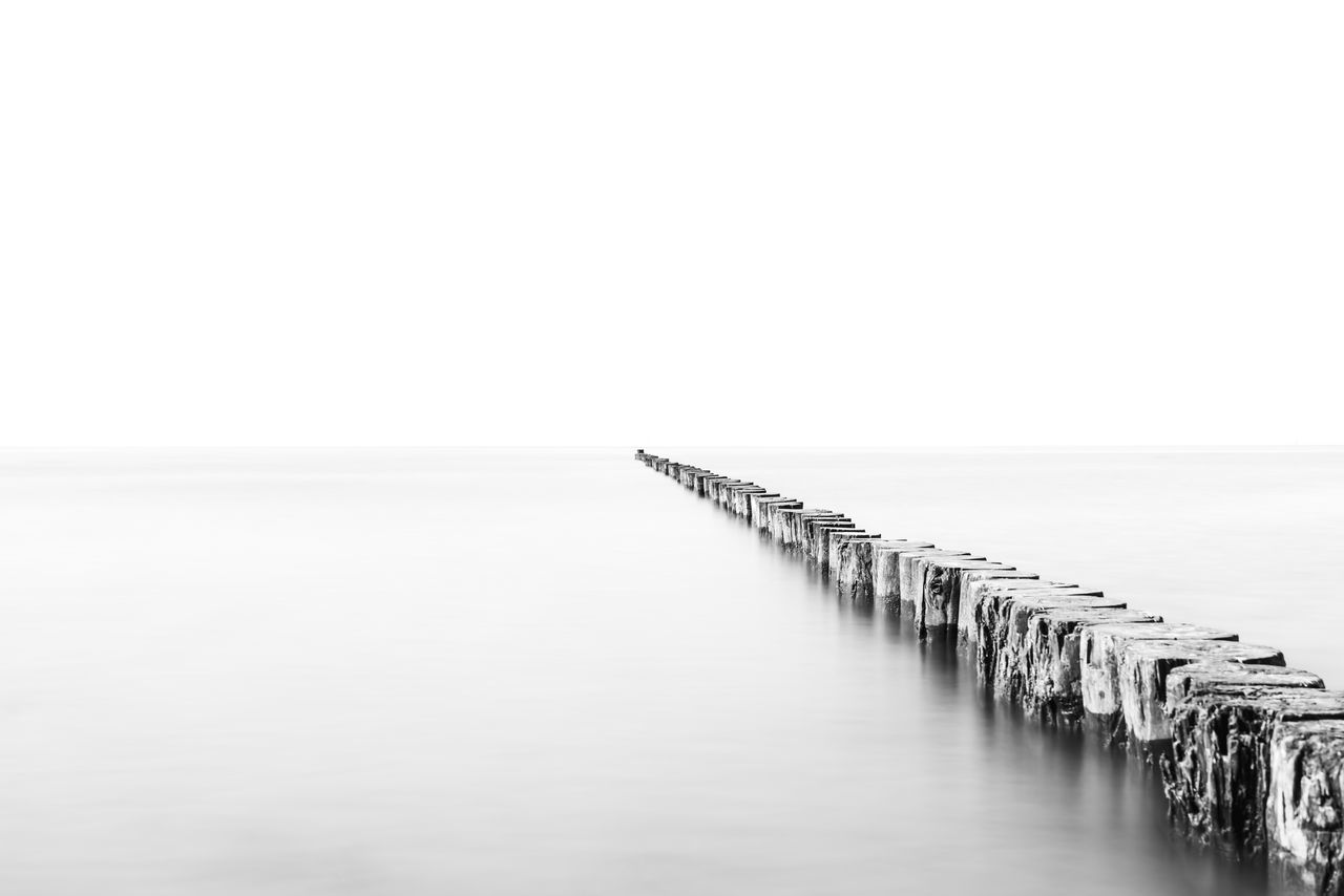 PIER OVER SEA AGAINST CLEAR SKY