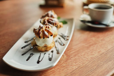 Cup of coffee and cake on table