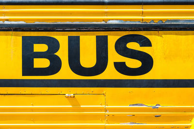 Close-up of text over metal on bus