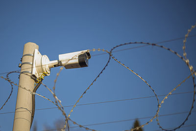 Camcorder on the fence. protected area. perimeter security. barbed wire and surveillance. 