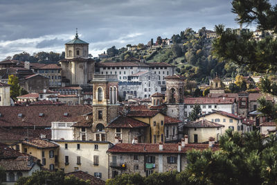 Buildings in town against sky